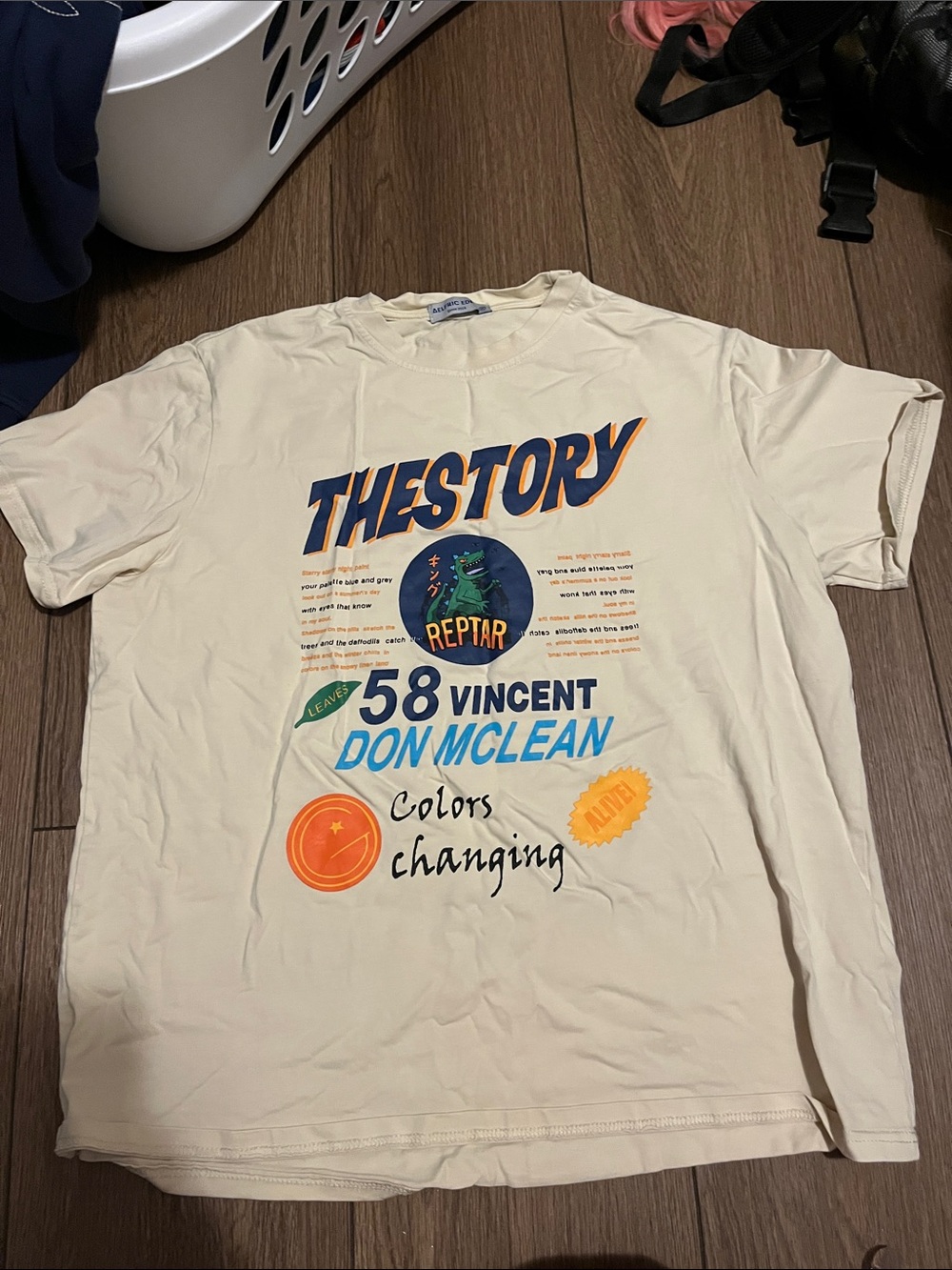 Aelfric Eden Cream Graphic 'THESTORY' Short Sleeve Tee with Blue & Orange Print